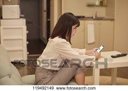 Stock Photo - Young Japanese woman in her house. Fotosearch
