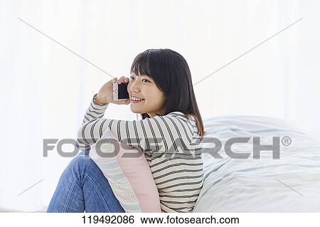 Young Japanese woman in her house View Large Photo Image Stock Photograph - Young Japanese woman in her house. Fotosearch