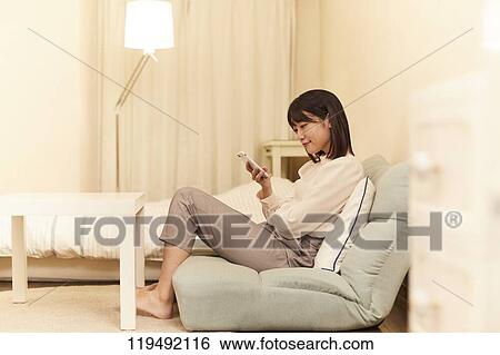 Stock Photograph - Young Japanese woman in her house. Fotosearch