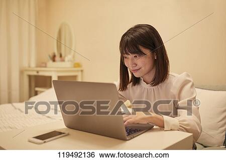 Stock Photograph - Young Japanese woman in her house. Fotosearch