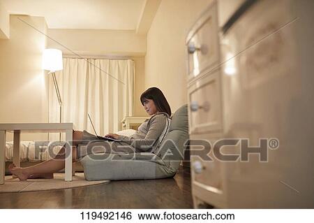 Stock Photograph - Young Japanese woman in her house. Fotosearch