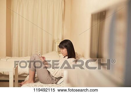 Stock Photography - Young Japanese woman in her house. Fotosearch