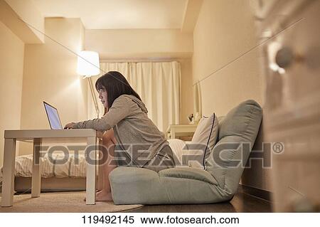 Stock Photography - Young Japanese woman in her house. Fotosearch