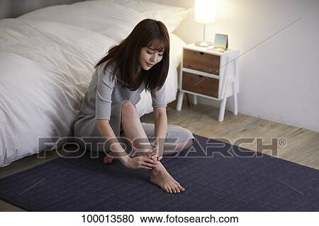 Stock Image - Young Japanese woman in the bedroom. Fotosearch