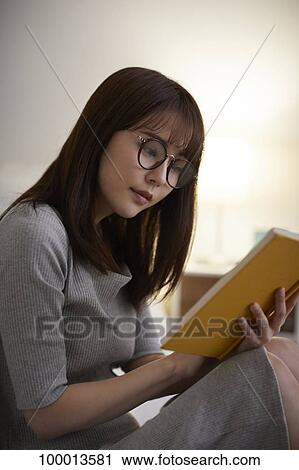 Stock Image - Young Japanese woman in the bedroom. Fotosearch