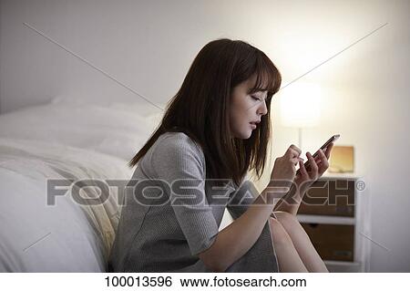 Stock Photograph - Young Japanese woman in the bedroom. Fotosearch