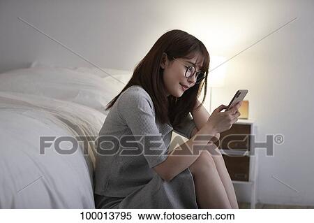 Young Japanese woman in the bedroom View Large Photo Image Stock Photography - Young Japanese woman in the bedroom. Fotosearch