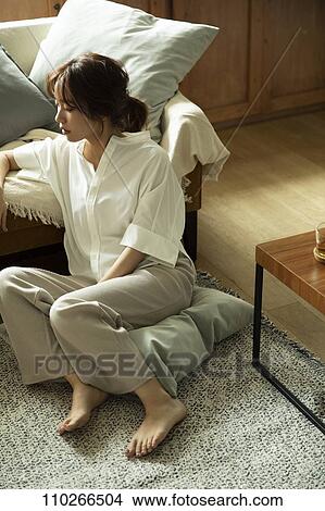 Young Japanese woman in the living room View Large Photo Image Picture - Young Japanese woman in the living room. Fotosearch