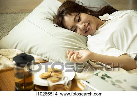 Young Japanese woman in the living room View Large Photo Image Picture - Young Japanese woman in the living room. Fotosearch