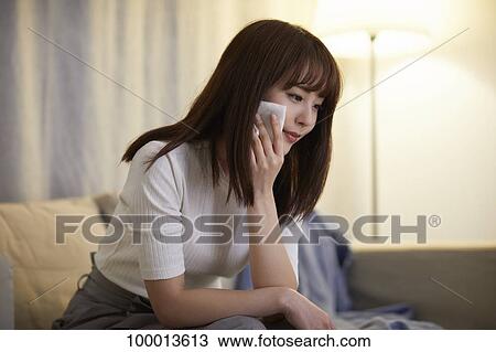 Young Japanese woman in the living room View Large Photo Image Stock Image - Young Japanese woman in the living room. Fotosearch
