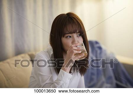 Young Japanese woman in the living room View Large Photo Image Stock Image - Young Japanese woman in the living room. Fotosearch
