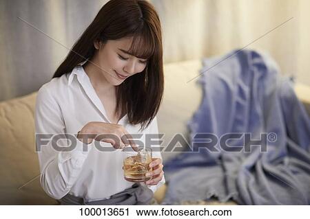 Young Japanese woman in the living room View Large Photo Image Stock Image - Young Japanese woman in the living room. Fotosearch