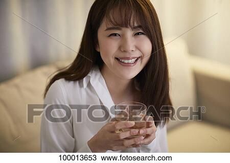Young Japanese woman in the living room View Large Photo Image Stock Image - Young Japanese woman in the living room. Fotosearch