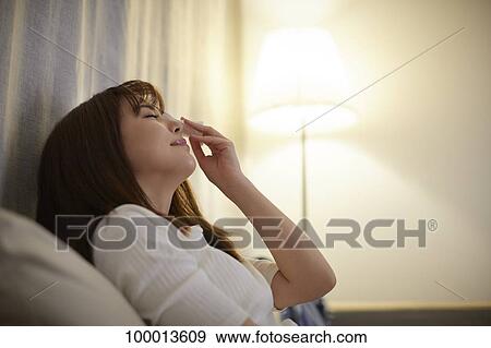 Young Japanese woman in the living room View Large Photo Image Stock Photo - Young Japanese woman in the living room. Fotosearch