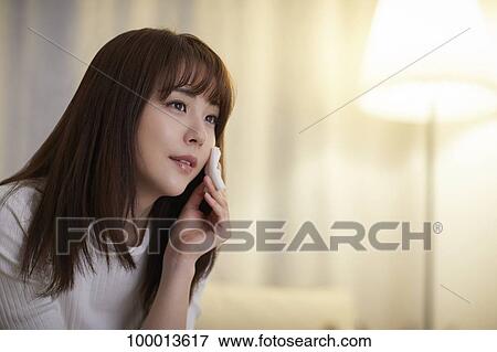 Young Japanese woman in the living room View Large Photo Image Stock Photo - Young Japanese woman in the living room. Fotosearch
