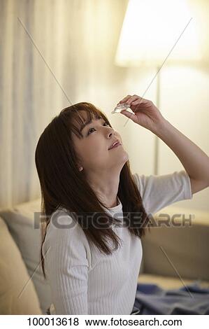Young Japanese woman in the living room View Large Photo Image Stock Photo - Young Japanese woman in the living room. Fotosearch