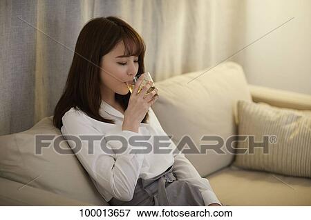 Young Japanese woman in the living room View Large Photo Image Stock Photo - Young Japanese woman in the living room. Fotosearch