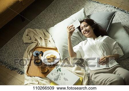 Young Japanese woman in the living room View Large Photo Image Stock Photo - Young Japanese woman in the living room. Fotosearch