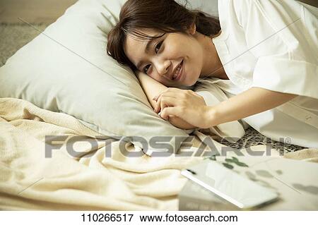 Young Japanese woman in the living room View Large Photo Image Stock Photo - Young Japanese woman in the living room. Fotosearch