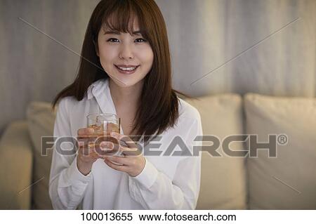 Young Japanese woman in the living room View Large Photo Image Stock Photography - Young Japanese woman in the living room. Fotosearch