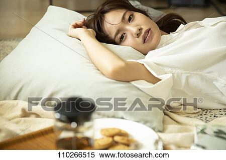 Young Japanese woman in the living room View Large Photo Image Stock Photography - Young Japanese woman in the living room. Fotosearch
