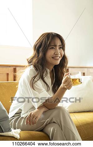 Young Japanese woman on the sofa View Large Photo Image Picture - Young Japanese woman on the sofa. Fotosearch