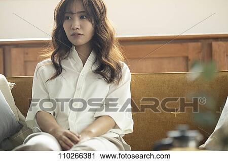 Young Japanese woman on the sofa View Large Photo Image Stock Image - Young Japanese woman on the sofa. Fotosearch