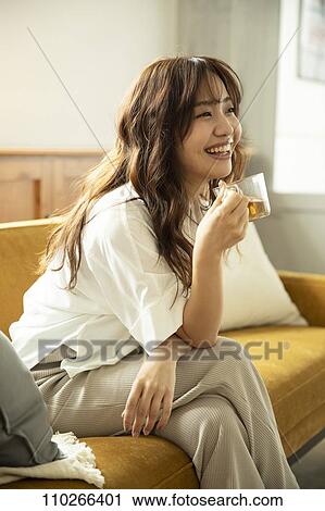 Young Japanese woman on the sofa View Large Photo Image Stock Image - Young Japanese woman on the sofa. Fotosearch