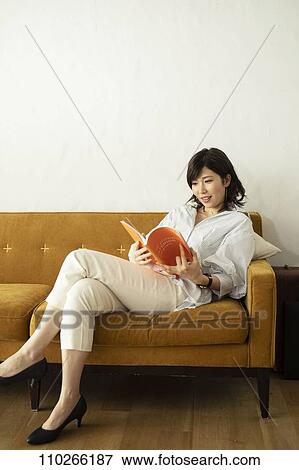 Young Japanese woman on the sofa View Large Photo Image Stock Photo - Young Japanese woman on the sofa. Fotosearch