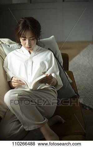 Young Japanese woman on the sofa View Large Photo Image Stock Photo - Young Japanese woman on the sofa. Fotosearch