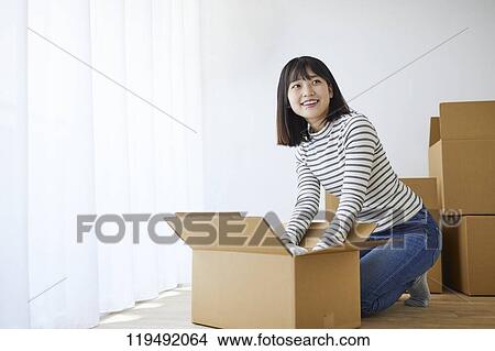 Young Japanese woman relocating View Large Photo Image Picture - Young Japanese woman relocating. Fotosearch