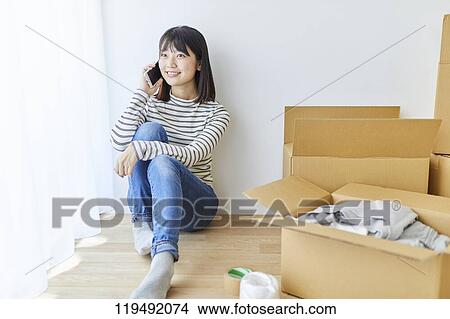 Young Japanese woman relocating View Large Photo Image Picture - Young Japanese woman relocating. Fotosearch