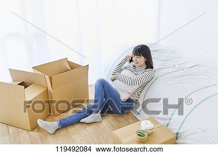 Young Japanese woman relocating View Large Photo Image Picture - Young Japanese woman relocating. Fotosearch