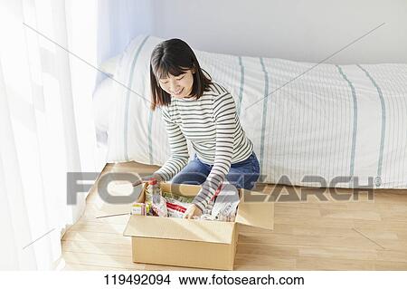 Young Japanese woman relocating View Large Photo Image Picture - Young Japanese woman relocating. Fotosearch