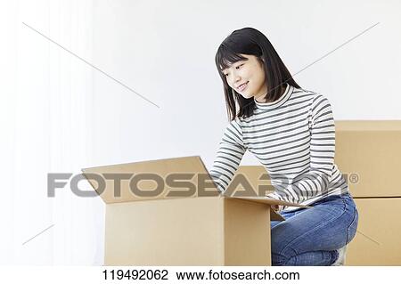 Young Japanese woman relocating View Large Photo Image Stock Image - Young Japanese woman relocating. Fotosearch