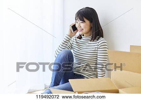 Young Japanese woman relocating View Large Photo Image Stock Image - Young Japanese woman relocating. Fotosearch