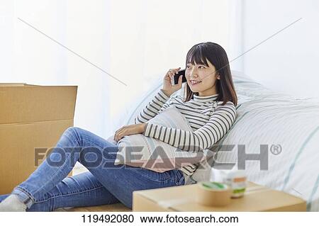 Young Japanese woman relocating View Large Photo Image Stock Image - Young Japanese woman relocating. Fotosearch