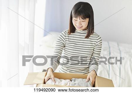 Young Japanese woman relocating View Large Photo Image Stock Image - Young Japanese woman relocating. Fotosearch