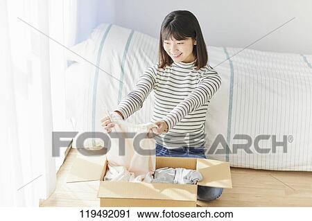 Young Japanese woman relocating View Large Photo Image Stock Image - Young Japanese woman relocating. Fotosearch