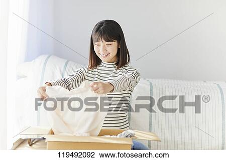 Young Japanese woman relocating View Large Photo Image Stock Image - Young Japanese woman relocating. Fotosearch