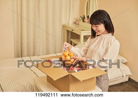 Young Japanese woman relocating View Large Photo Image Stock Image - Young Japanese woman relocating. Fotosearch