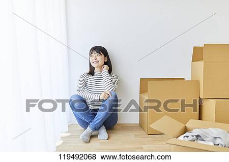 Young Japanese woman relocating View Large Photo Image Stock Photo - Young Japanese woman relocating. Fotosearch