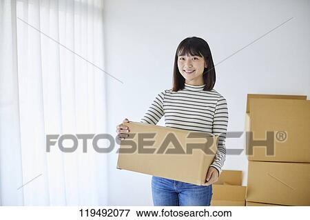 Young Japanese woman relocating View Large Photo Image Stock Photo - Young Japanese woman relocating. Fotosearch