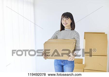 Young Japanese woman relocating View Large Photo Image Stock Photo - Young Japanese woman relocating. Fotosearch