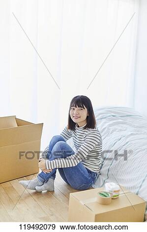 Stock Photo - Young Japanese woman relocating. Fotosearch