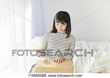 Young Japanese woman relocating View Large Photo Image Stock Photo - Young Japanese woman relocating. Fotosearch