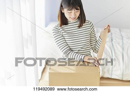 Young Japanese woman relocating View Large Photo Image Stock Photo - Young Japanese woman relocating. Fotosearch