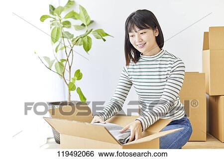 Stock Photograph - Young Japanese woman relocating. Fotosearch