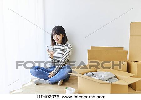 Young Japanese woman relocating View Large Photo Image Stock Photograph - Young Japanese woman relocating. Fotosearch