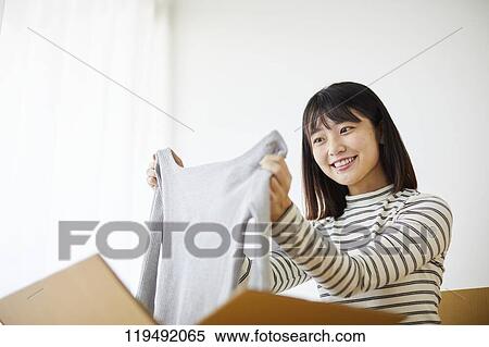 Young Japanese woman relocating View Large Photo Image Stock Photography - Young Japanese woman relocating. Fotosearch
